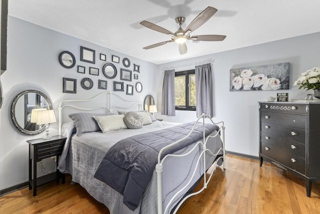 bedroom with ceiling fan and wood-type flooring