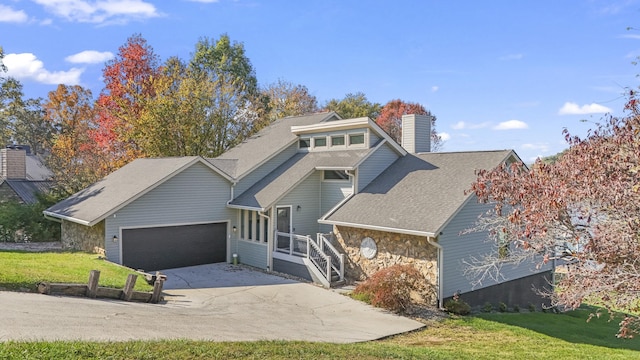 view of front of property featuring a garage and a front yard