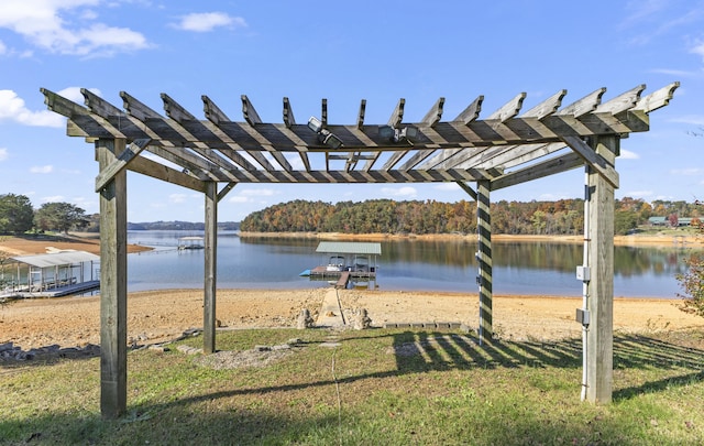 dock area with a pergola, a yard, and a water view