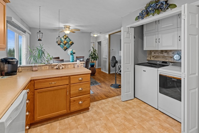 kitchen with ceiling fan, tasteful backsplash, white dishwasher, decorative light fixtures, and washer and dryer