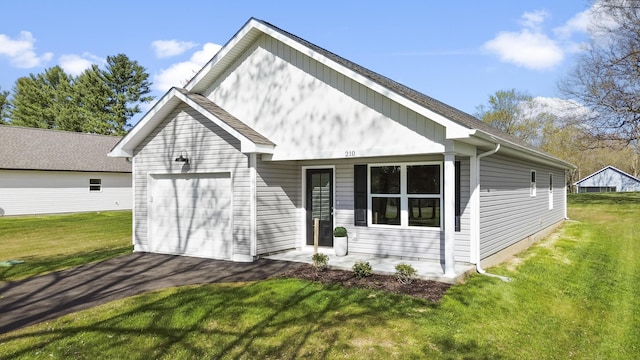 view of front of property featuring driveway, covered porch, a garage, and a front lawn