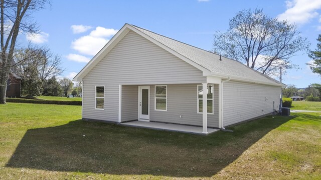 rear view of property with central air condition unit, a patio, and a yard