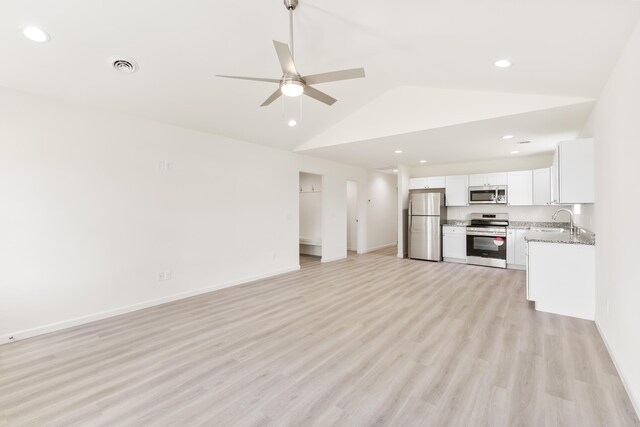 unfurnished living room featuring vaulted ceiling, baseboards, light wood-style floors, ceiling fan, and visible vents