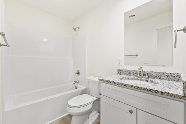 full bathroom with toilet, vanity, and shower / bathtub combination