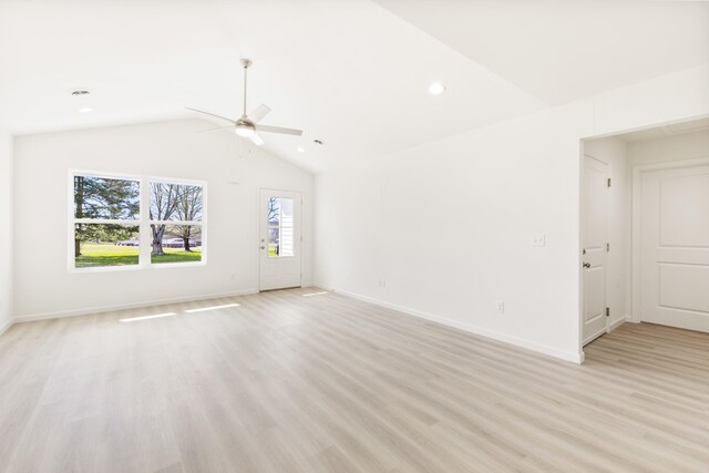 empty room with a ceiling fan, light wood-style flooring, baseboards, and lofted ceiling