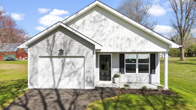 view of front of property with driveway, a front lawn, and an attached garage