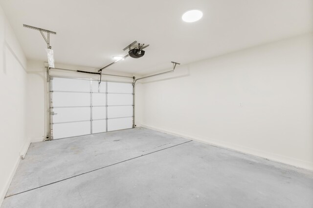 garage featuring baseboards and a garage door opener