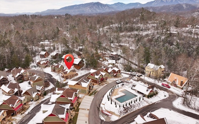 snowy aerial view with a mountain view