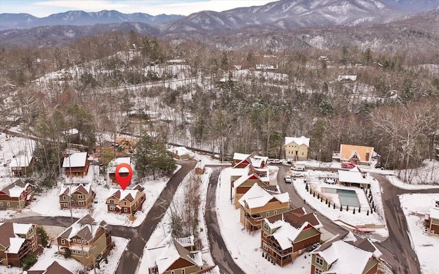 snowy aerial view with a mountain view