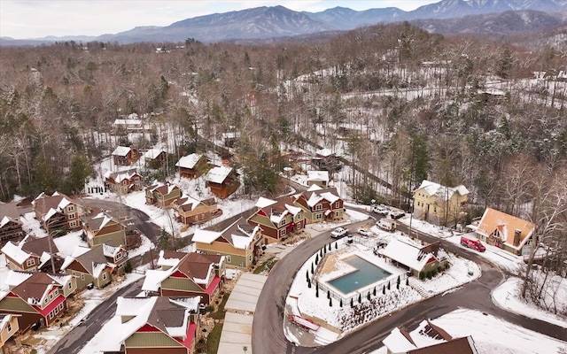 snowy aerial view with a mountain view