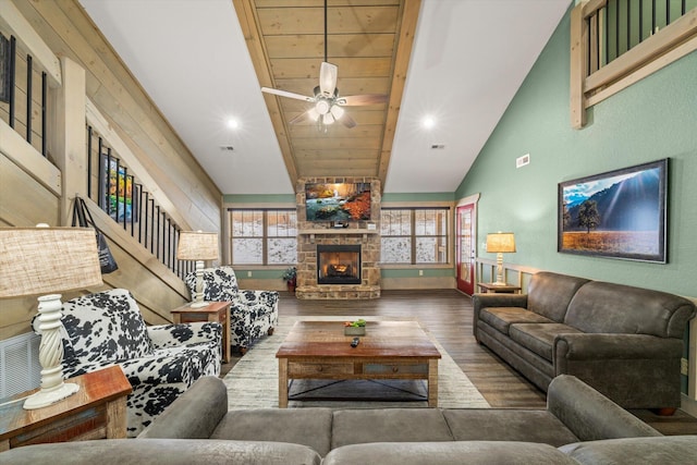 living room featuring hardwood / wood-style floors, ceiling fan, a fireplace, and vaulted ceiling