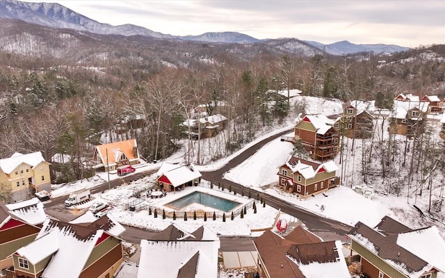 snowy aerial view with a mountain view