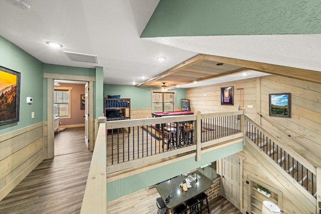 interior space featuring hardwood / wood-style floors and wooden walls