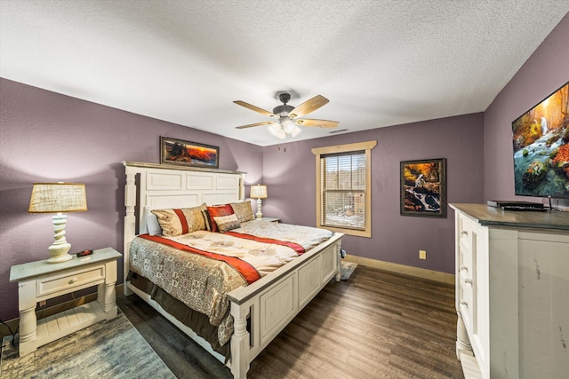 bedroom featuring a textured ceiling, ceiling fan, and dark hardwood / wood-style floors