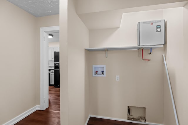 laundry area with dark wood finished floors, laundry area, washer hookup, and baseboards