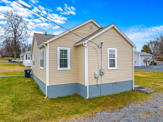 view of property exterior with a yard and crawl space