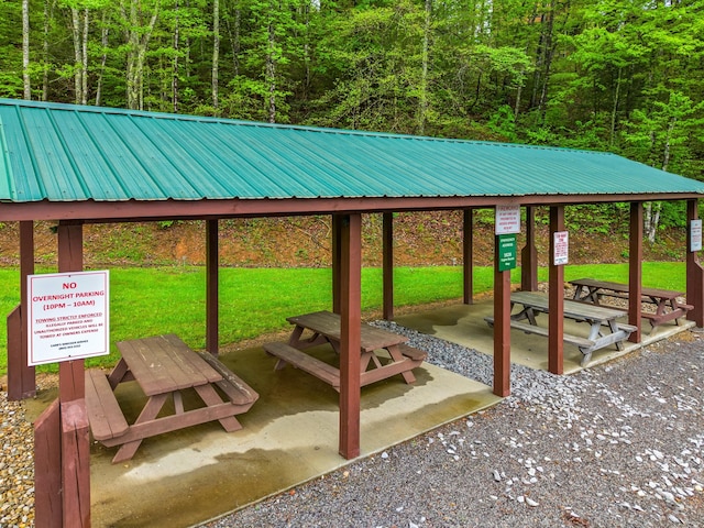 surrounding community featuring a wooded view and a yard