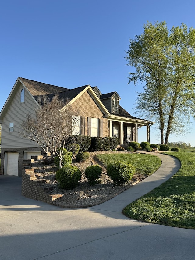 view of front of property with concrete driveway, brick siding, and a garage