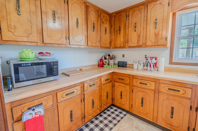 625 Trentham Hollow Rd, Parrottsville, TN 37843 - kitchen with stainless steel microwave, light countertops, and brown cabinetry