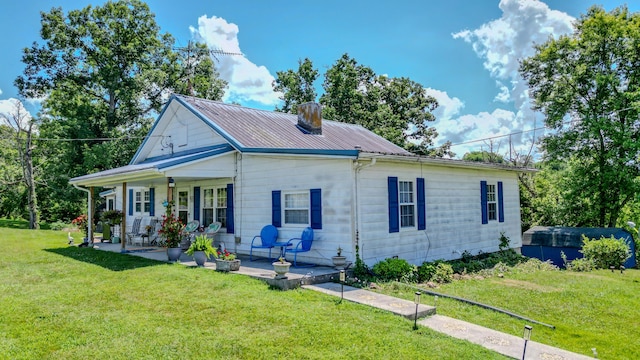 625 Trentham Hollow Rd, Parrottsville, TN 37843 - view of front of home featuring a porch, a front lawn, a metal roof, and a chimney