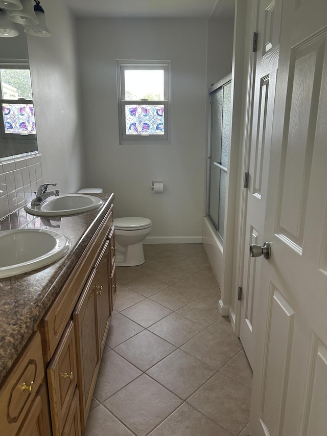 2151 Thomas Dr, Morristown, TN 37814 - bathroom featuring plenty of natural light, double vanity, tile patterned flooring, and enclosed tub / shower combo