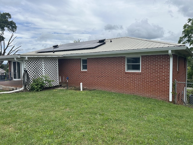 2151 Thomas Dr, Morristown, TN 37814 - view of side of property with solar panels, a metal roof, and brick siding