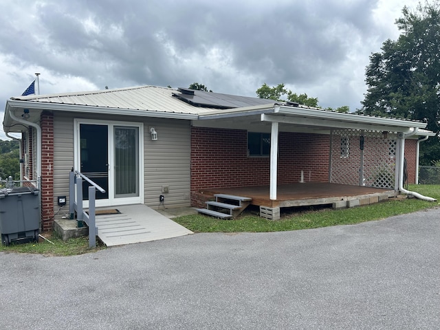 2151 Thomas Dr, Morristown, TN 37814 - rear view of property with solar panels, brick siding, and a metal roof
