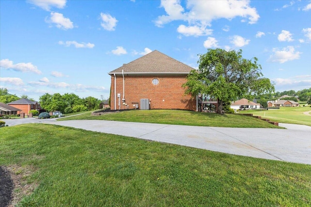 419 Colonial St, Jefferson City, TN 37760 - view of side of property featuring a lawn, brick siding, driveway, and central AC