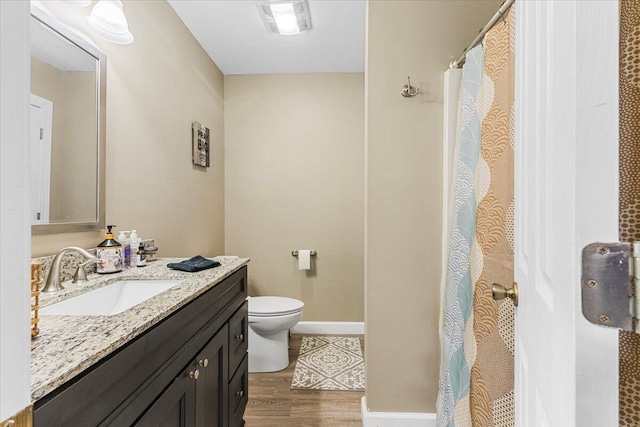 419 Colonial St, Jefferson City, TN 37760 - bathroom with wood finished floors, toilet, vanity, and baseboards