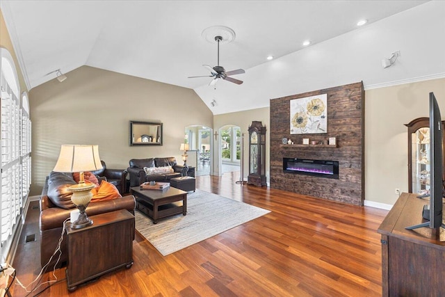 419 Colonial St, Jefferson City, TN 37760 - living room featuring vaulted ceiling, ceiling fan, wood finished floors, a large fireplace, and arched walkways