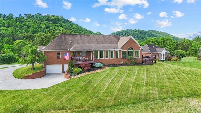 419 Colonial St, Jefferson City, TN 37760 - view of front of property with brick siding, concrete driveway, a wooden deck, and an attached garage
