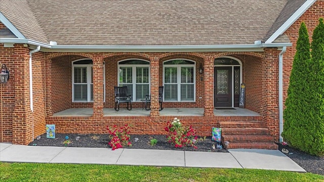 419 Colonial St, Jefferson City, TN 37760 - doorway to property with a porch, a shingled roof, and brick siding