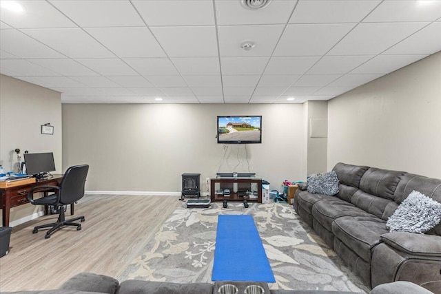 419 Colonial St, Jefferson City, TN 37760 - living room featuring wood finished floors, a paneled ceiling, recessed lighting, baseboards, and a wood stove