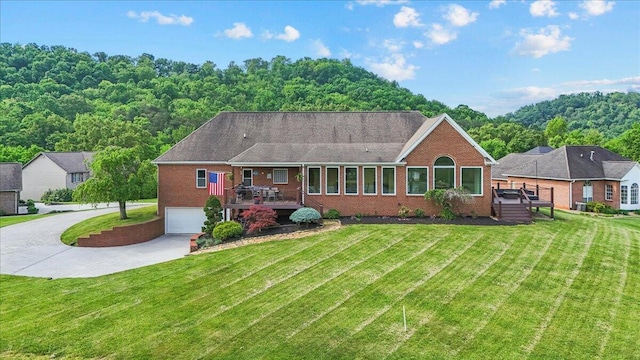 419 Colonial St, Jefferson City, TN 37760 - back of property with driveway, brick siding, and a lawn