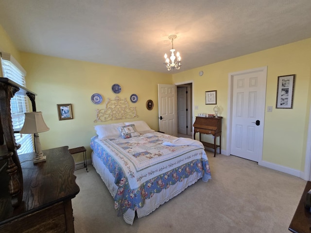 carpeted bedroom featuring baseboards and a notable chandelier