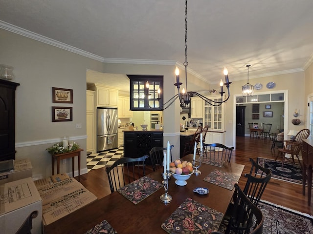 dining room featuring baseboards, ornamental molding, dark wood-style flooring, and a chandelier