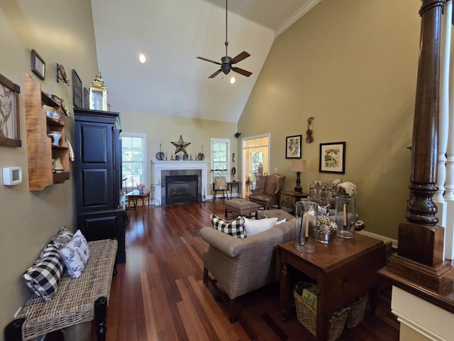 living room featuring high vaulted ceiling, dark wood finished floors, ceiling fan, and a fireplace