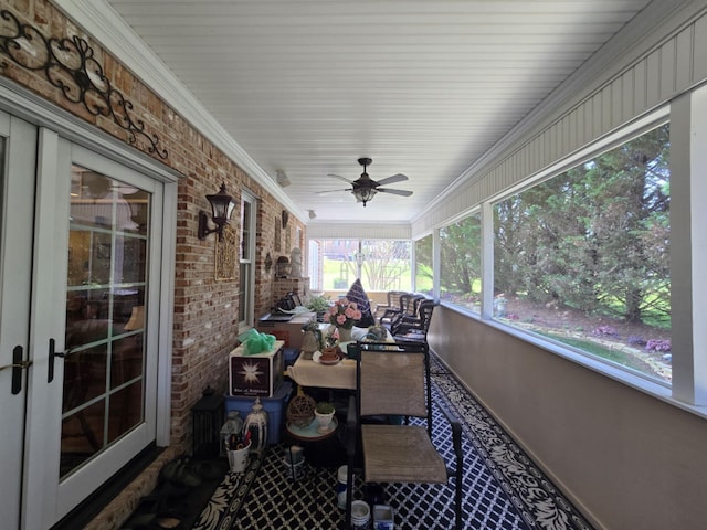 sunroom / solarium featuring a ceiling fan