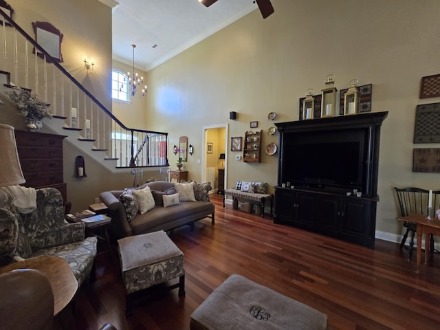 living area featuring wood finished floors, high vaulted ceiling, ceiling fan with notable chandelier, ornamental molding, and stairs