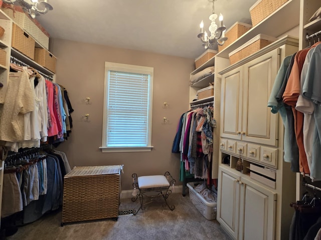 spacious closet with an inviting chandelier and carpet floors