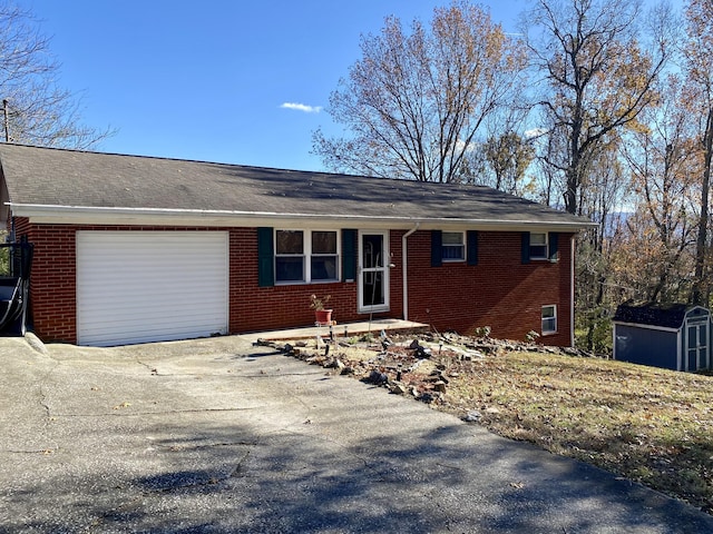 single story home with a storage unit and a garage