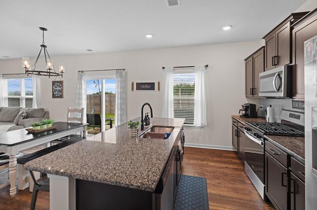 525 Cliff St, Morristown, TN 37814 - kitchen with appliances with stainless steel finishes, a sink, a chandelier, dark brown cabinets, and dark stone counters