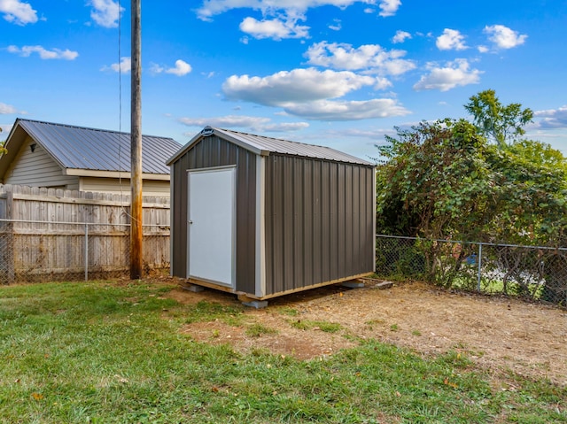 view of outbuilding featuring a yard