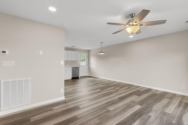 unfurnished living room with ceiling fan and hardwood / wood-style floors