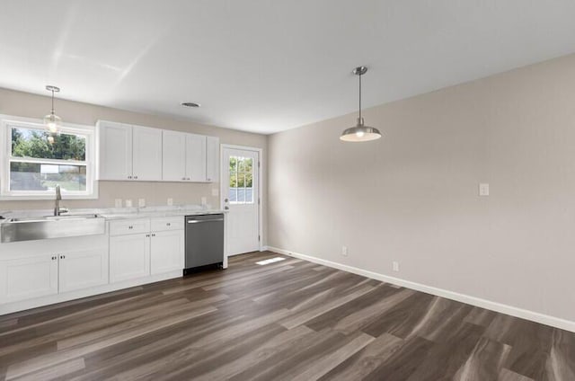 kitchen featuring sink, white cabinets, stainless steel dishwasher, and decorative light fixtures