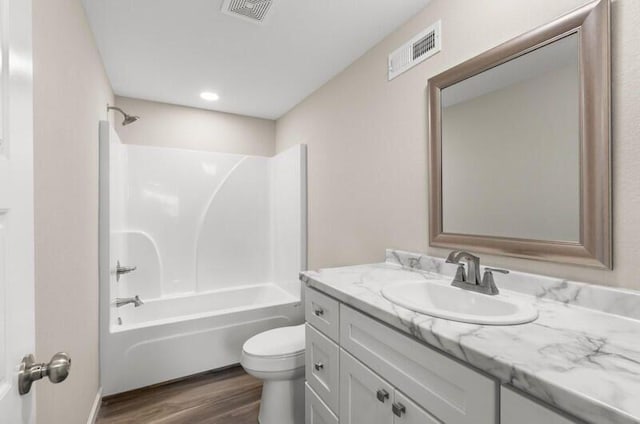 full bathroom featuring vanity,  shower combination, toilet, and wood-type flooring