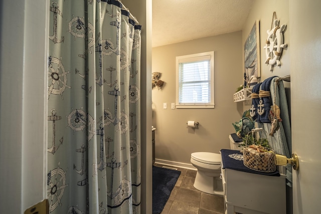 bathroom with vanity, a textured ceiling, and toilet