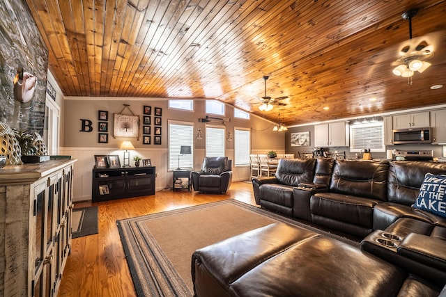 cinema with ornamental molding, wood ceiling, ceiling fan, light hardwood / wood-style floors, and lofted ceiling