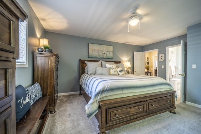 bedroom featuring carpet flooring, connected bathroom, multiple windows, and ceiling fan