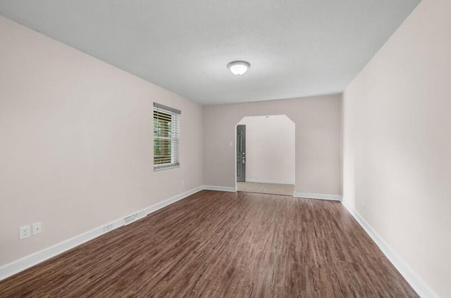 4061 Julian Ave, Morristown, TN 37814 - spare room with dark wood-style floors, arched walkways, and baseboards